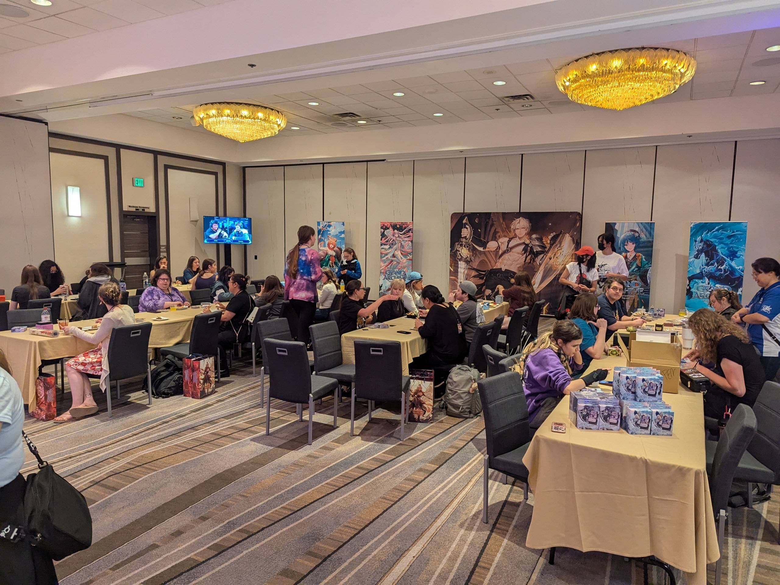 A Grand Archive TCG tournament venue full of players seated at tables during a competitive event